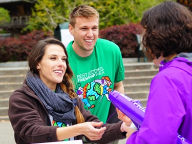 image of people volunteering at an event check in station