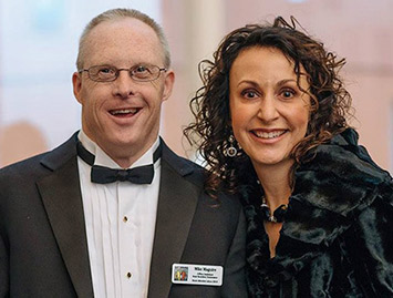 Two advisory board members standing side by side in formal attire