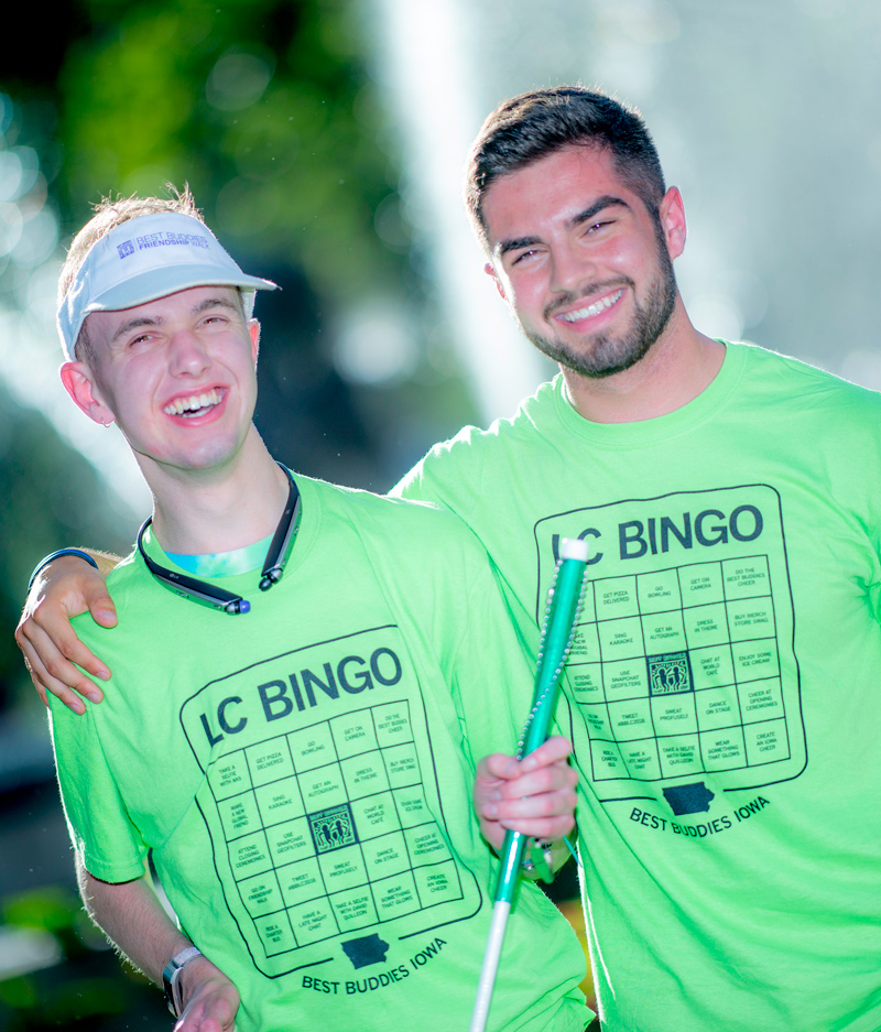 Two male participants with arms over shoulders