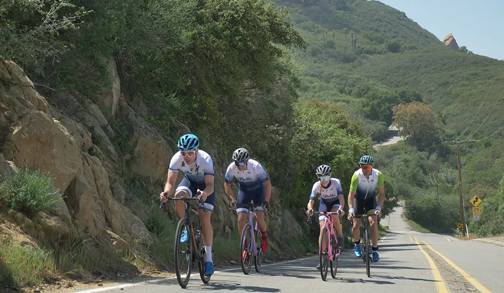 Group of cyclists with mountains in the background