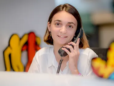 Best Buddies Jobs participant smiling while answering the phone