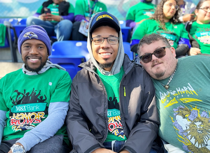 Three participants smiling at the camera