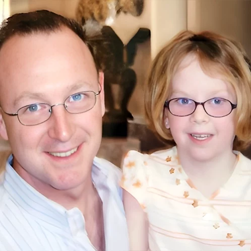 Heartwarming scene: Father and daughter smiling.